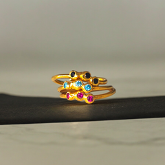 Adjustable Doty ring with red, blue, and black zircons