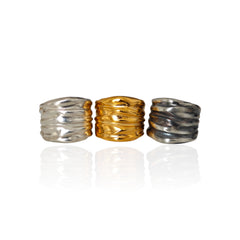 Athenais wide draped rings in silver, gold plated and oxidized finishes on white background