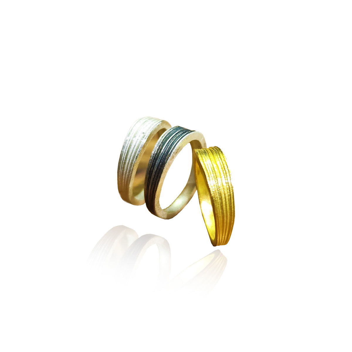 Two gold rings with textured bands on a white background