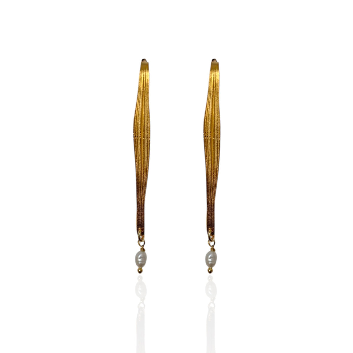 Pair of long, thin earrings with a central pearl on a white background