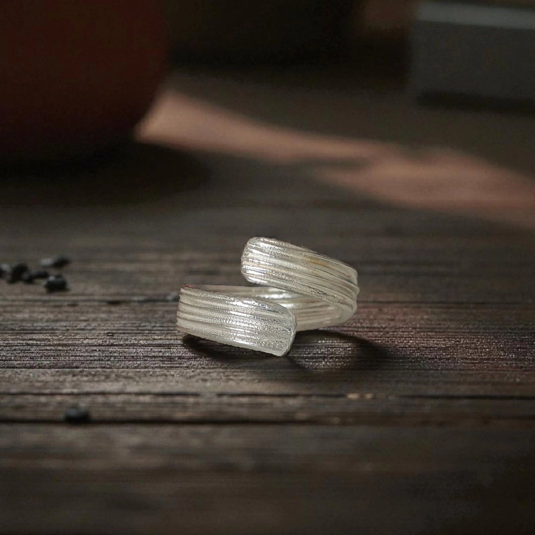 Two clear crystal rings on a wooden surface with a blurred background