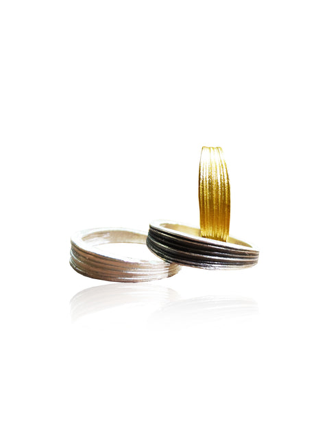 Two gold and silver rings on a white background