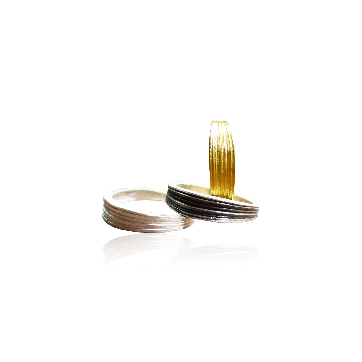 Two gold and silver rings on a white background