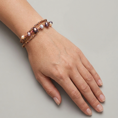 Handmade pearl cord bracelet with layered wax cords worn on wrist