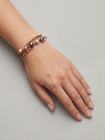 Handmade pearl cord bracelet with layered wax cords worn on wrist