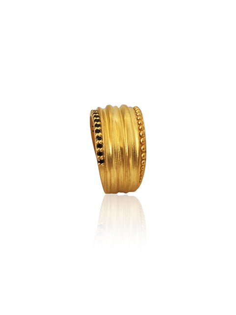 Gold ring with a textured design on a white background