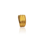 Gold ring with a textured design on a white background
