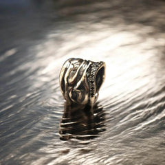 Handmade Athenais Notos Ring in silver with flowing folds and zircon details