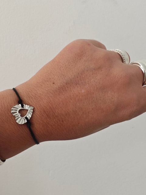 Handmade heart cord bracelet worn on wrist
