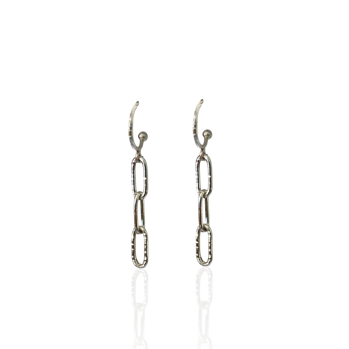 Pair of silver chain link earrings on a white background