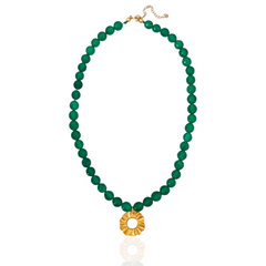 Green beaded necklace with a gold pendant on a white background