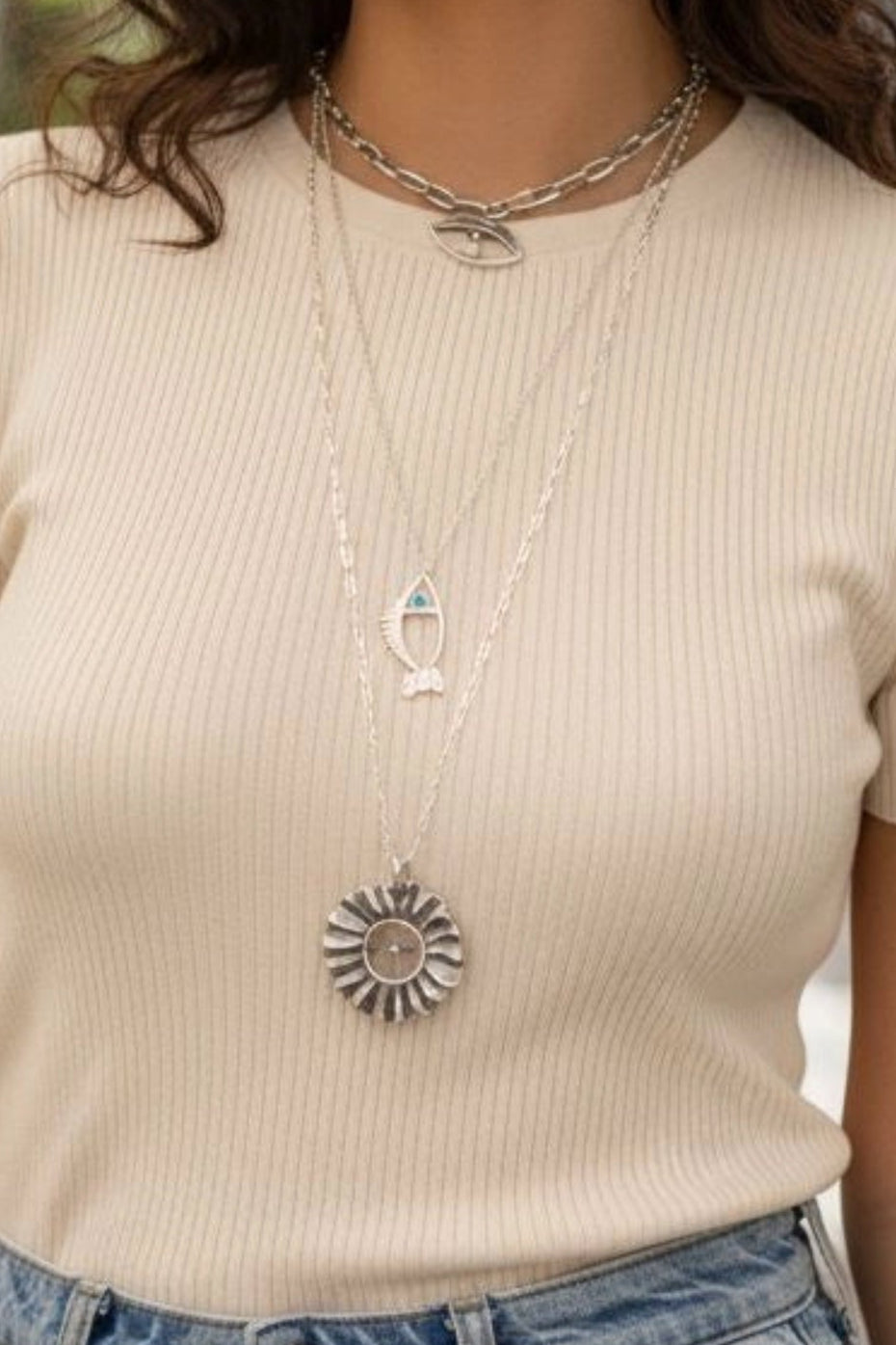 Galene fish necklace worn on model in silver with light blue zircon
