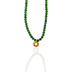Green jade beaded necklace with Helios charm pendant on white background