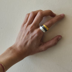 Hand wearing a ring on a plain background