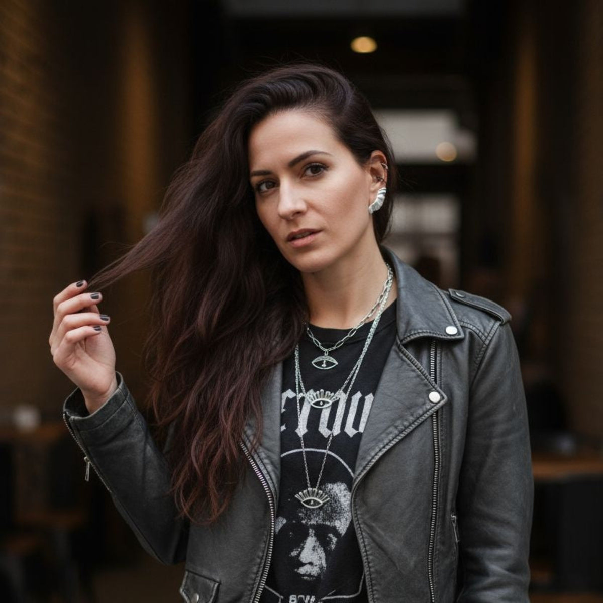 Woman wearing Aether wing ear climber earrings in sterling silver, street style