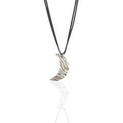 Silver crescent moon pendant on a black cord against a white background