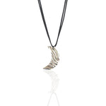 Silver crescent moon pendant on a black cord against a white background