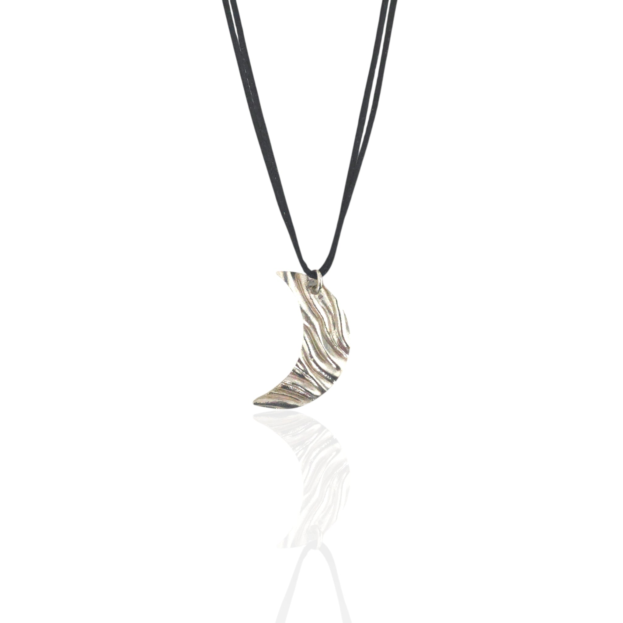 Silver crescent moon pendant on a black cord against a white background