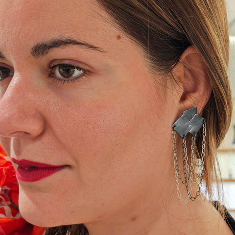 Model wearing Bouquet Rocker Earrings – bold geometric earrings with silver chains.