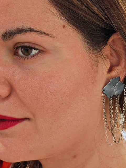 Model wearing Bouquet Rocker Earrings – bold geometric earrings with silver chains.
