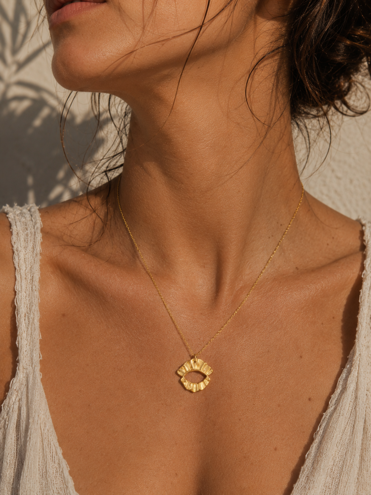 Woman wearing Athenart Veiled Eye Necklace, contemporary handmade Greek jewelry inspired by ancient protective symbols.