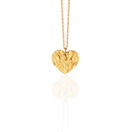 Gold heart-shaped necklace on a white background. Greek jewelry wholesale. Love symbol