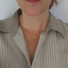 Argus tiny eye charm necklace worn – gold-plated on neckline – Athenart