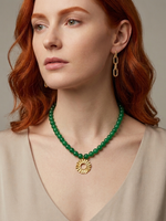 Green agate necklace with Helios sun charm worn on model