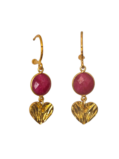 Gold heart earrings with ruby gemstones on a white background