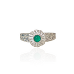 Silver ring with a green gemstone on a white background