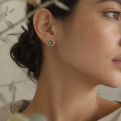 Nerida green and pearl stud earring worn on a woman’s ear showing its delicate 8 mm size