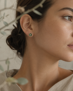 Nerida green and pearl stud earring worn on a woman’s ear showing its delicate 8 mm size