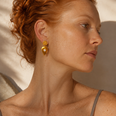 Editorial portrait of a ginger-haired model wearing Kelifos Pearl Stud Earrings.