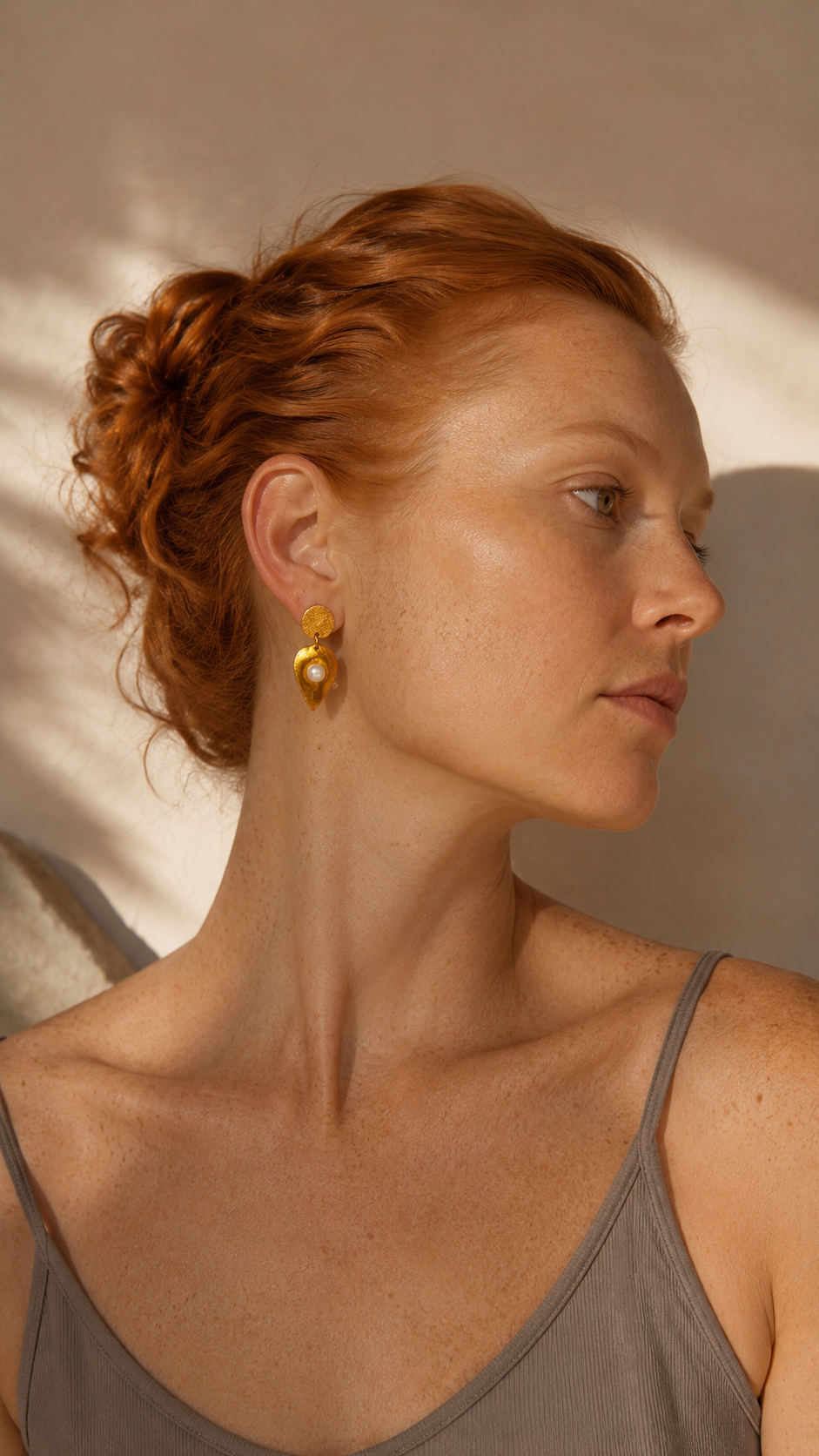 Editorial portrait of a ginger-haired model wearing Kelifos Pearl Stud Earrings.