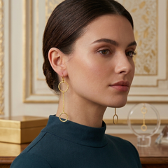 Woman wearing gold hoop earrings with a decorative background
