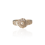 sILVER ring with a pearl center on a white background