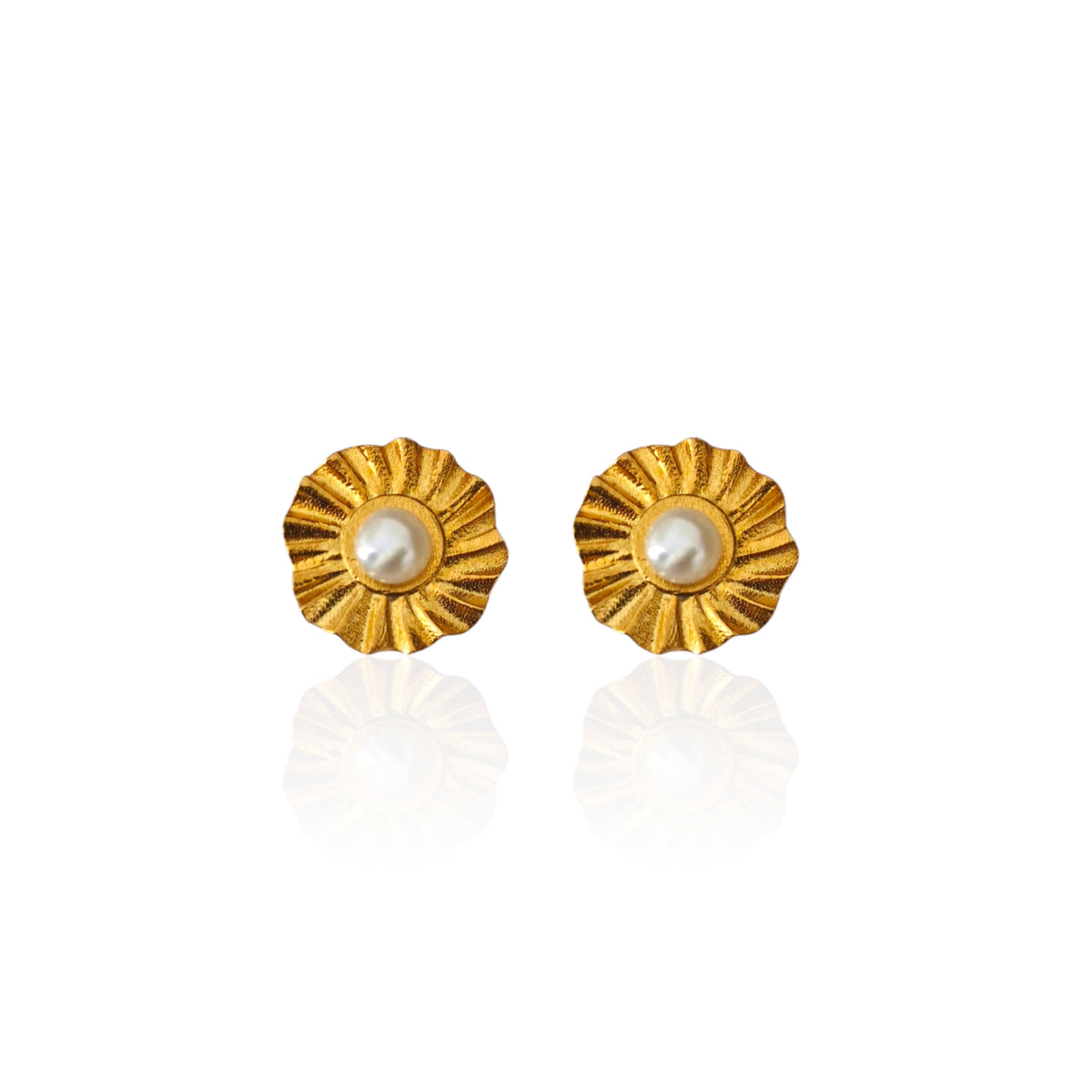 Helios sunburst stud earrings with white pearl center on white background