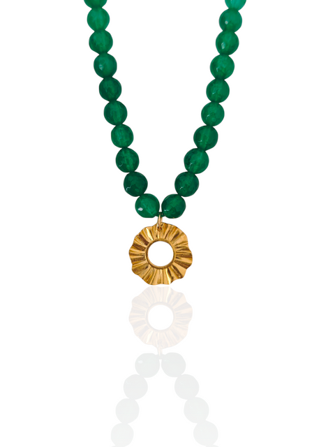 Green beaded necklace with a gold pendant on a white background