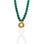 Green beaded necklace with a gold pendant on a white background