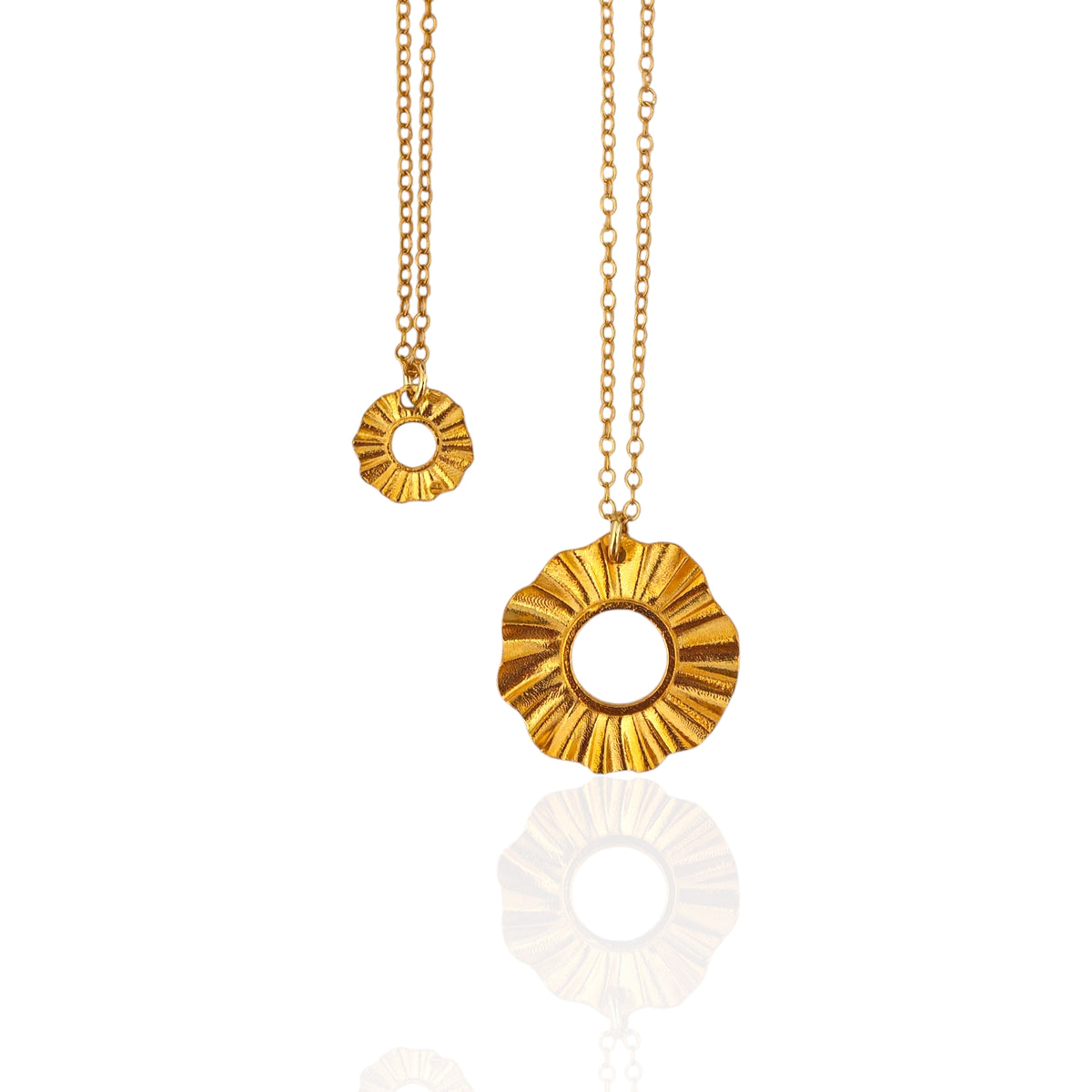 Helios Guardian Sun lucky charm pendants in silver and gold-plated on chains, product photo on white, Athenart Jewelry.