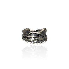 Athenais Hemline Ring in oxidized 925 silver with draped folds and beaded hem on white background.