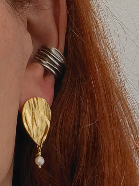 Close-up of Peplos pearl drop earring on ear, gold plated finish with oxidized ear cuff