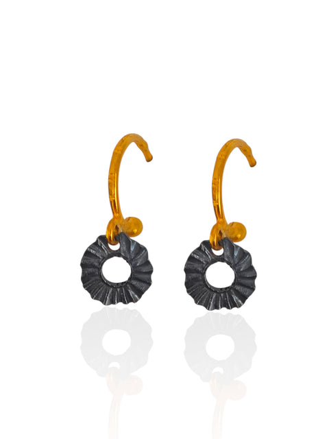 Handmade Greek hoop earrings with sculptural black oxidized sun charms