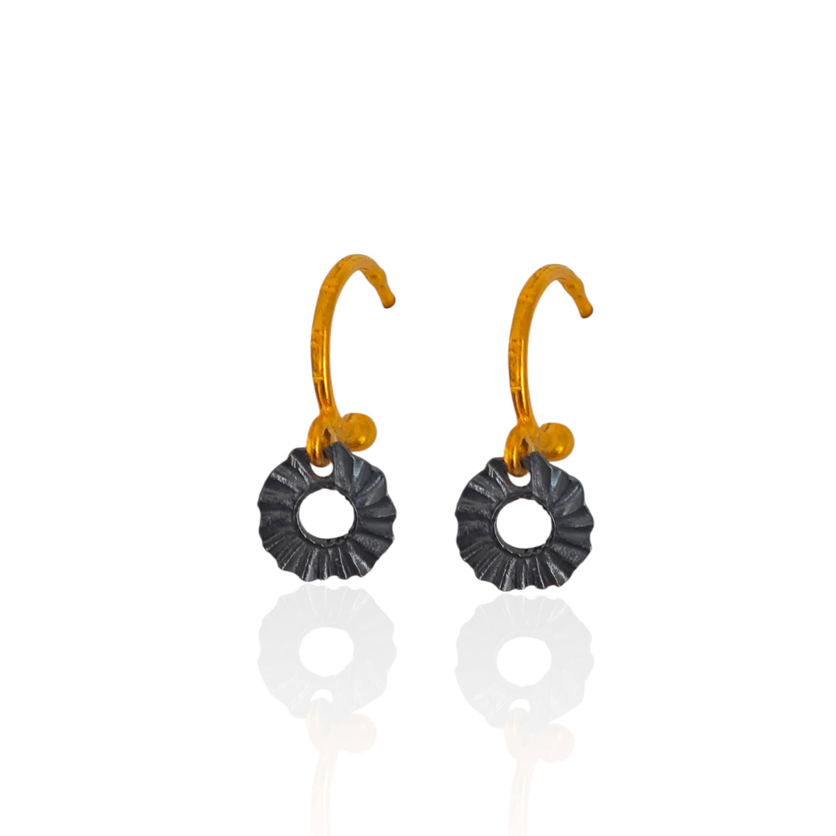 Handmade Greek hoop earrings with sculptural black oxidized sun charms