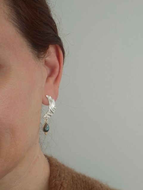 Labradorite moon earrings worn on ear, silver crescent with gemstone drop