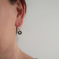 Helios mini hoop earrings worn on ear with gold and oxidized silver contrast