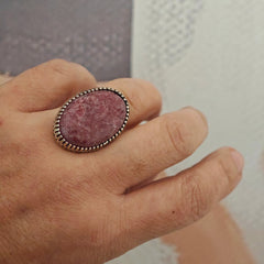 One-of-a-kind oval pink stone ring in sterling silver worn on hand, size 58–58.5
