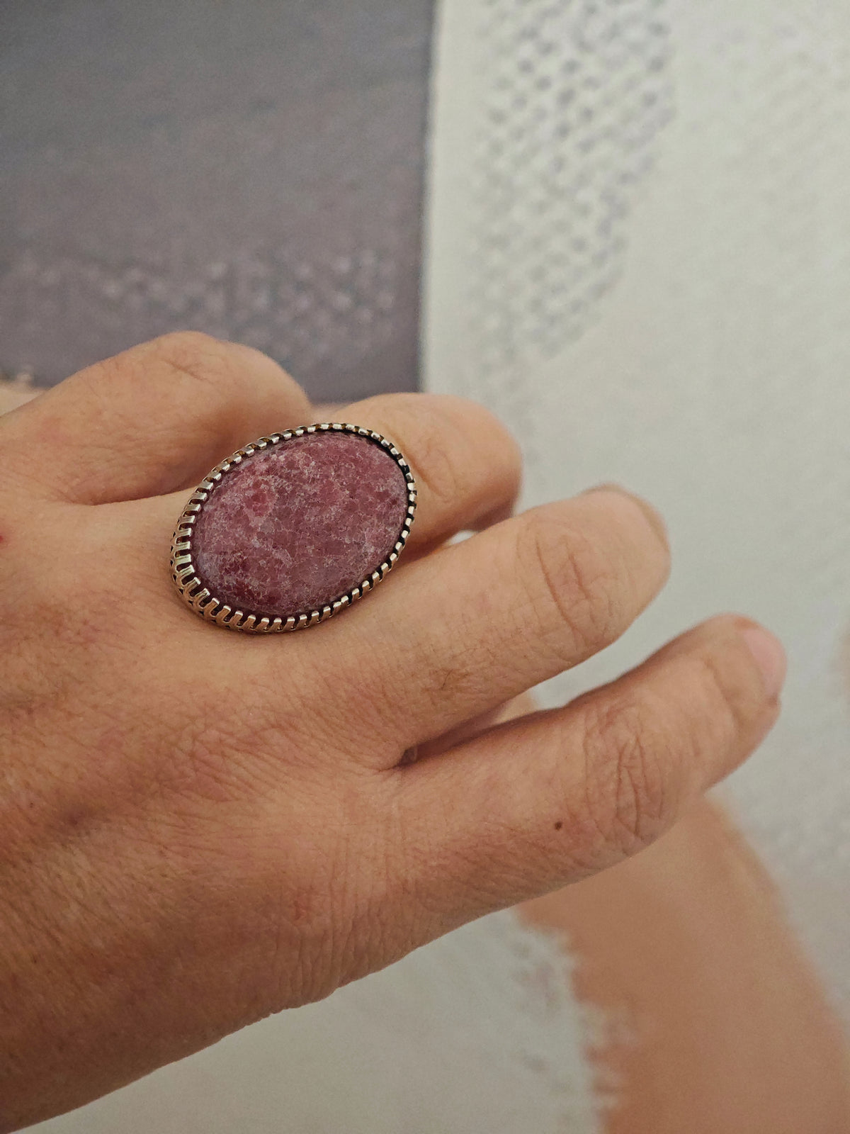 One-of-a-kind oval pink stone ring in sterling silver worn on hand, size 58–58.5