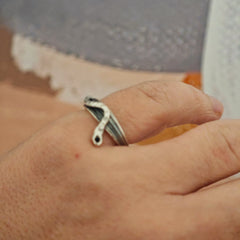 One-of-a-kind sterling silver serpent ring with oxidized details on grey surface, size 53