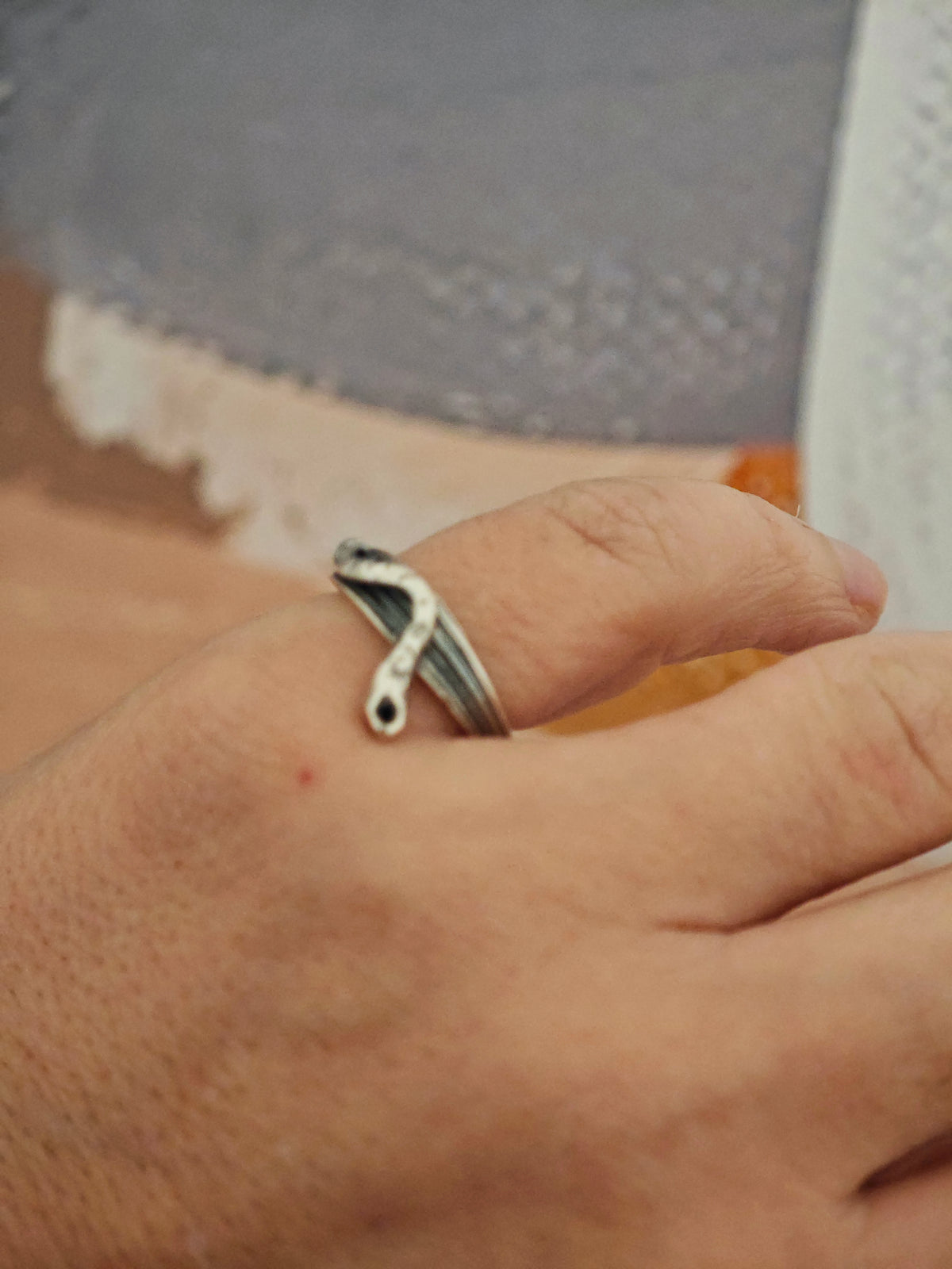 One-of-a-kind sterling silver serpent ring with oxidized details on grey surface, size 53